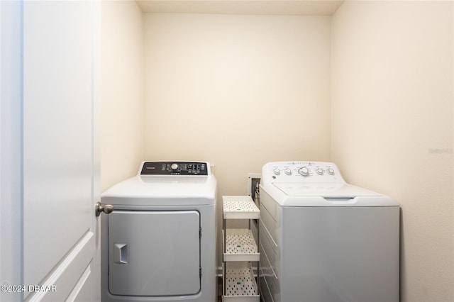 laundry room featuring washing machine and clothes dryer