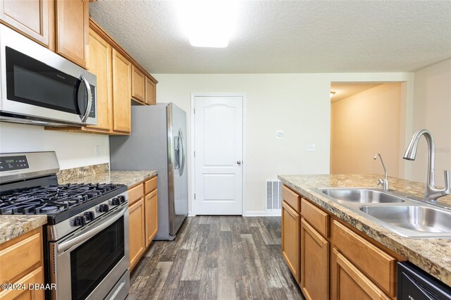 kitchen featuring dark hardwood / wood-style flooring, a textured ceiling, sink, and stainless steel appliances