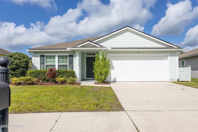 ranch-style house featuring a front lawn and a garage