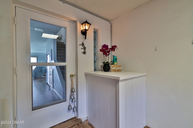 doorway with hardwood / wood-style floors