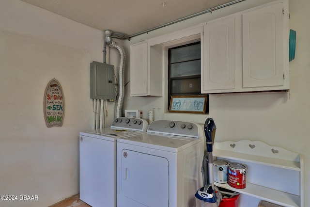 washroom with electric panel, cabinets, and independent washer and dryer