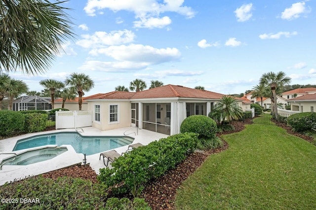 view of pool featuring a sunroom, a yard, and an in ground hot tub