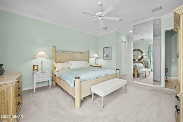 carpeted bedroom featuring a closet, ceiling fan, and ornamental molding