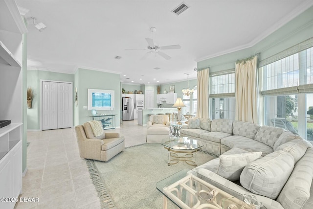 living room featuring light tile patterned floors, ceiling fan with notable chandelier, and ornamental molding