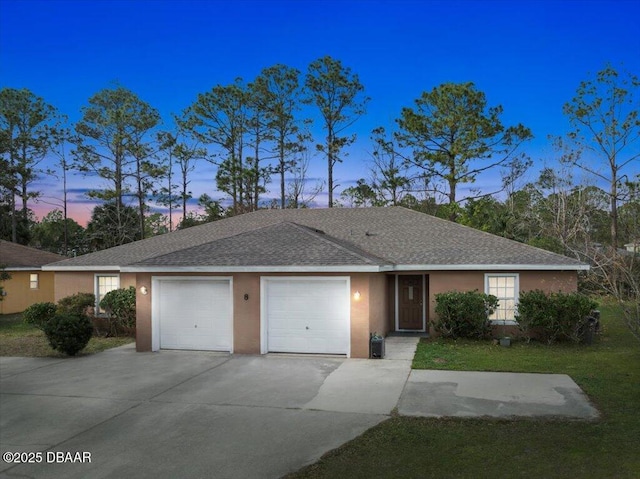 ranch-style home with roof with shingles, driveway, an attached garage, and stucco siding