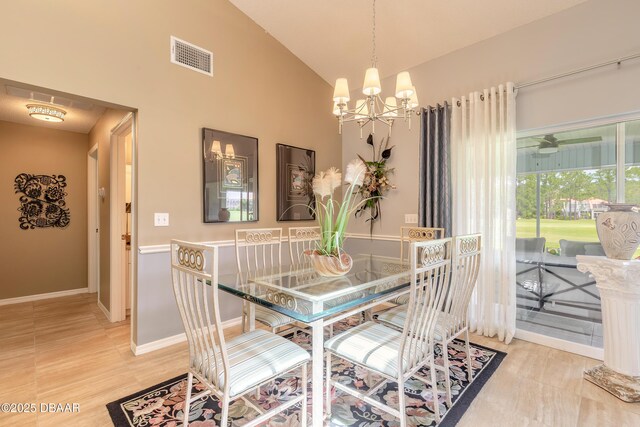 6273 Paradise Island Ct, Port Orange, FL 32128 - dining space with a chandelier, high vaulted ceiling, and baseboards