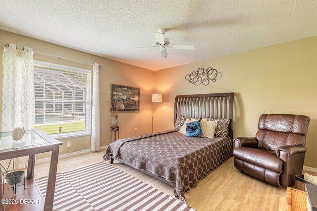 6273 Paradise Island Ct, Port Orange, FL 32128 - bedroom featuring a textured ceiling, baseboards, a ceiling fan, and tile patterned flooring