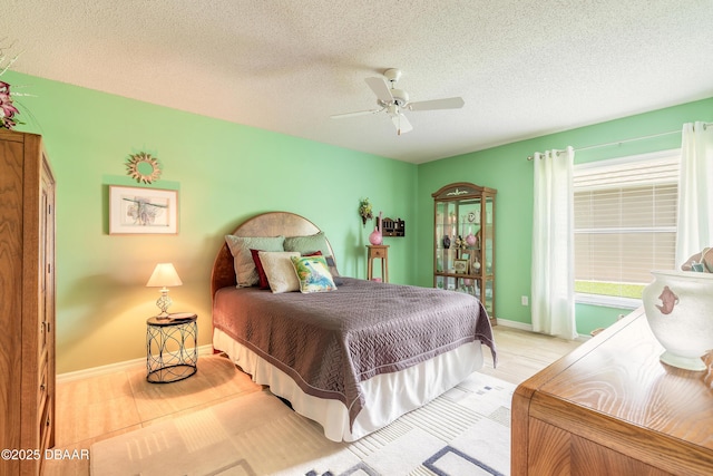 6273 Paradise Island Ct, Port Orange, FL 32128 - bedroom featuring wood finished floors, a textured ceiling, baseboards, and a ceiling fan