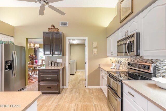 6273 Paradise Island Ct, Port Orange, FL 32128 - kitchen featuring appliances with stainless steel finishes, white cabinetry, light countertops, washer / clothes dryer, and a ceiling fan