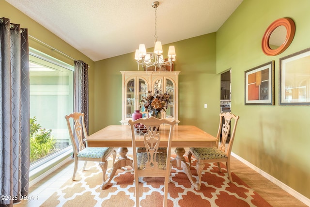 6273 Paradise Island Ct, Port Orange, FL 32128 - dining area with a chandelier, lofted ceiling, baseboards, and light wood finished floors
