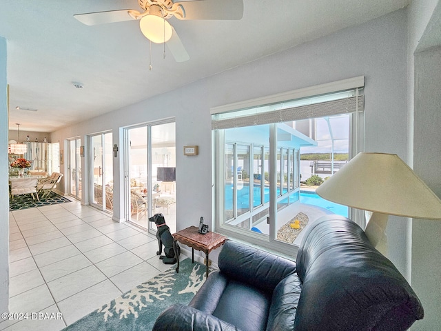 tiled living room featuring a wealth of natural light and ceiling fan