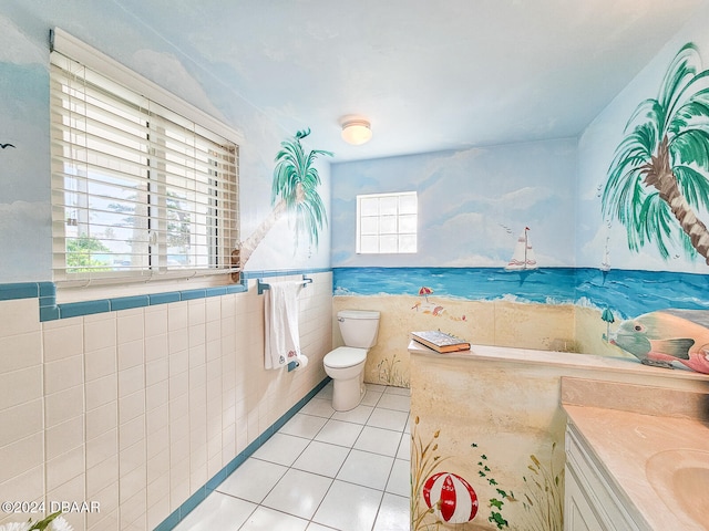 bathroom with tile patterned floors, a healthy amount of sunlight, toilet, and tile walls