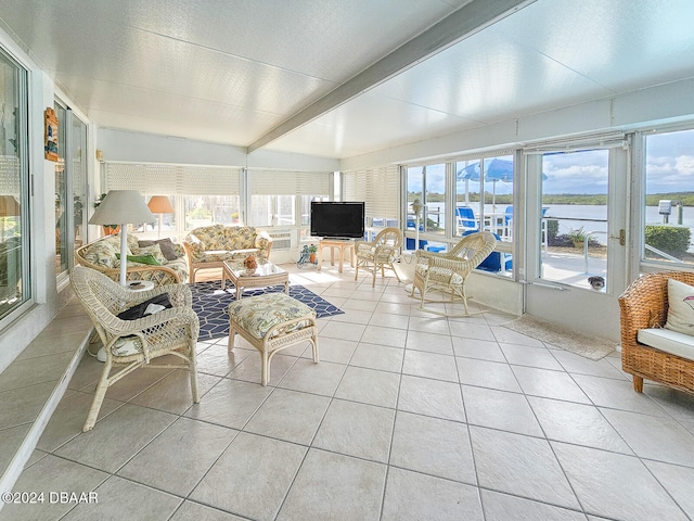 sunroom featuring vaulted ceiling with beams and a wealth of natural light