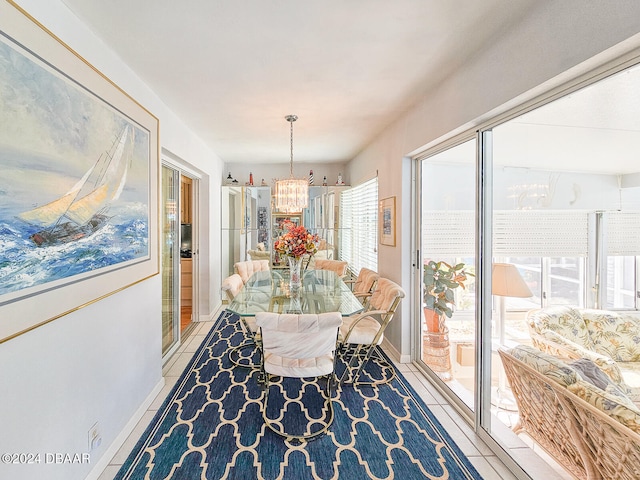 dining area with light tile patterned floors and a notable chandelier