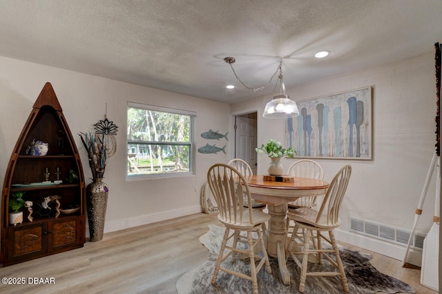 22 Cedar St, Port Orange, FL 32127 - dining room featuring baseboards, wood finished floors, a textured ceiling, and recessed lighting