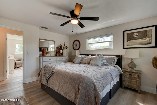 22 Cedar St, Port Orange, FL 32127 - bedroom featuring multiple windows, light wood-style flooring, and baseboards