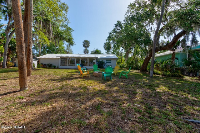 22 Cedar St, Port Orange, FL 32127 - rear view of house with metal roof and a lawn