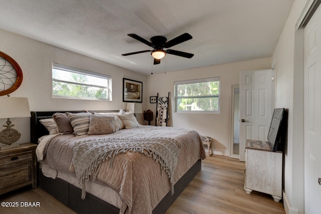 22 Cedar St, Port Orange, FL 32127 - bedroom featuring multiple windows, wood finished floors, baseboards, and ceiling fan