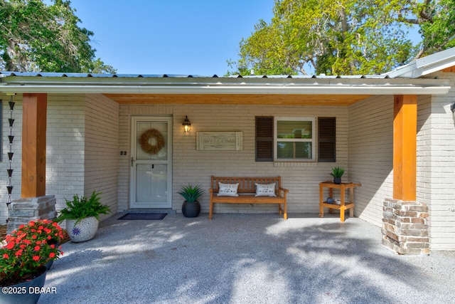 22 Cedar St, Port Orange, FL 32127 - doorway to property featuring brick siding