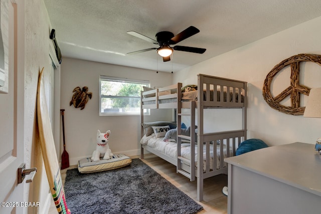 22 Cedar St, Port Orange, FL 32127 - bedroom featuring wood finished floors, ceiling fan, and a textured ceiling