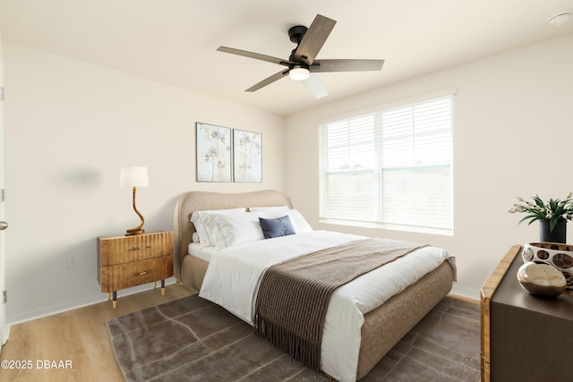 bedroom with wood finished floors, baseboards, and ceiling fan