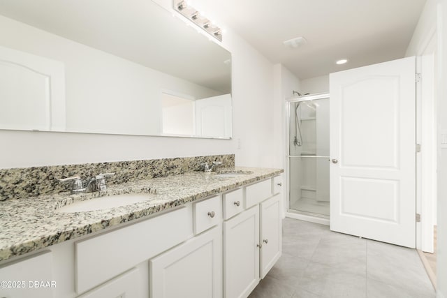 bathroom with a stall shower, tile patterned floors, double vanity, and recessed lighting