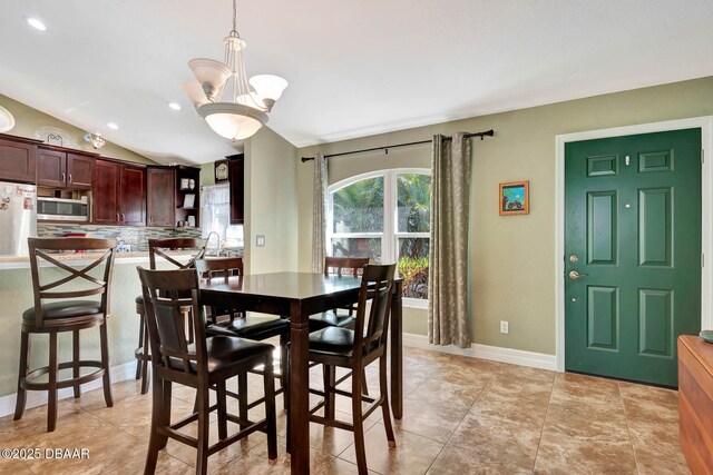 5479 Saint Regis Way, Port Orange, FL 32128 - dining space featuring vaulted ceiling, recessed lighting, and a chandelier