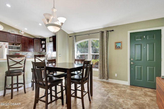 5479 Saint Regis Way, Port Orange, FL 32128 - dining room featuring lofted ceiling, recessed lighting, and a chandelier