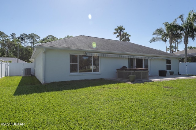 5479 Saint Regis Way, Port Orange, FL 32128 - rear view of property featuring a hot tub, a fenced backyard, and stucco siding