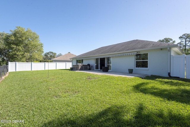 5479 Saint Regis Way, Port Orange, FL 32128 - rear view of house with a fenced backyard, a patio, and stucco siding