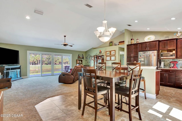 5479 Saint Regis Way, Port Orange, FL 32128 - dining area with light colored carpet, a chandelier, a ceiling fan, recessed lighting, and lofted ceiling