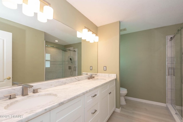 5479 Saint Regis Way, Port Orange, FL 32128 - bathroom featuring double vanity, a shower stall, and wood finished floors