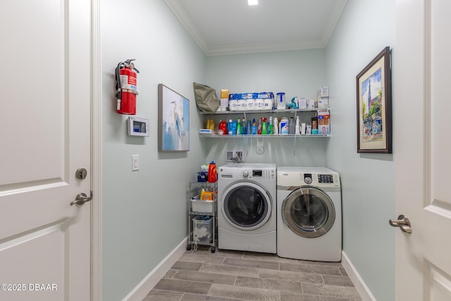 laundry room featuring ornamental molding and washing machine and dryer