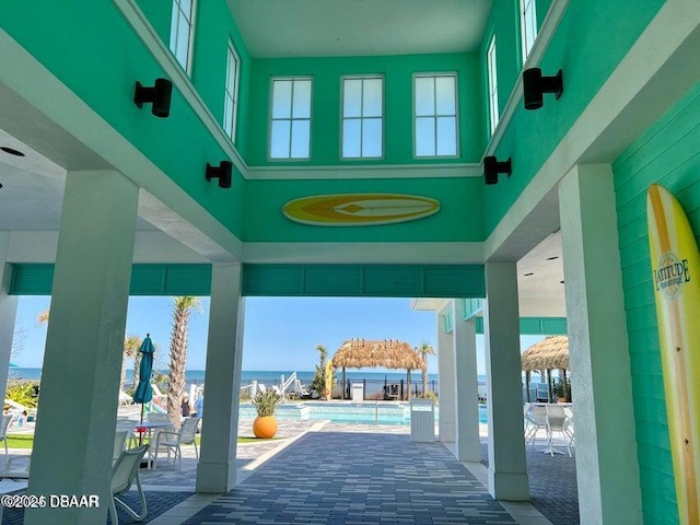 view of patio / terrace featuring a community pool and a water view