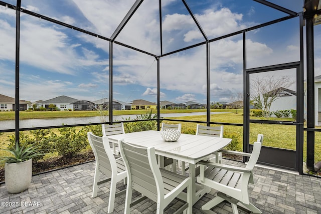 sunroom / solarium with a water view