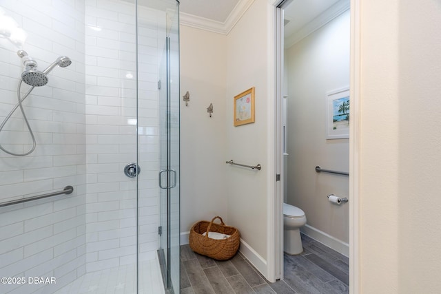 bathroom with ornamental molding, walk in shower, and toilet