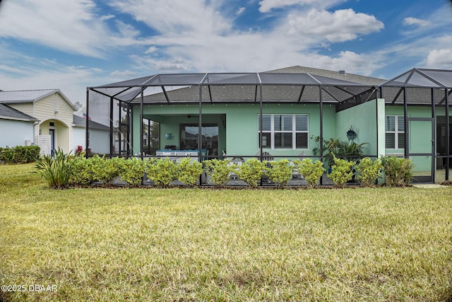 back of house featuring a lawn and glass enclosure