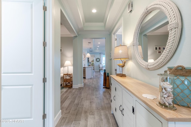 corridor with crown molding and light hardwood / wood-style flooring