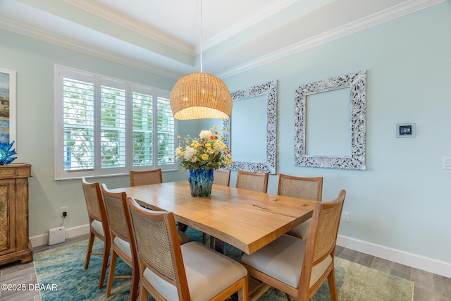 dining area featuring crown molding and hardwood / wood-style flooring