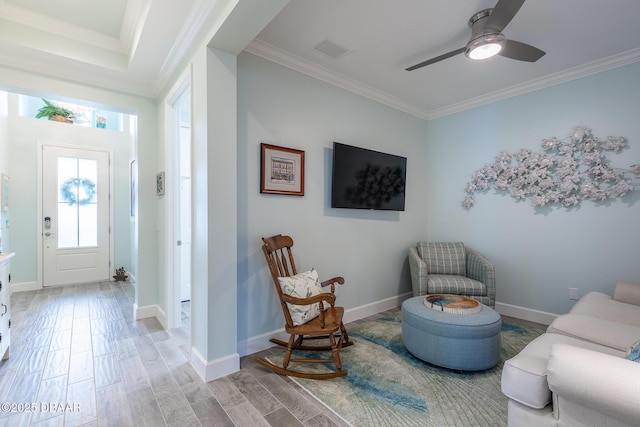 interior space featuring hardwood / wood-style flooring, ceiling fan, and ornamental molding