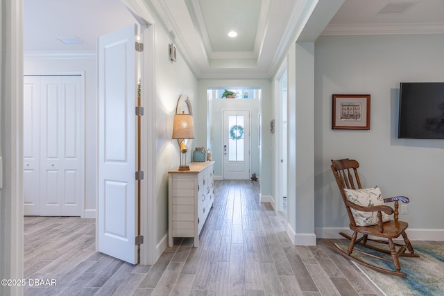 entrance foyer with crown molding and light hardwood / wood-style flooring