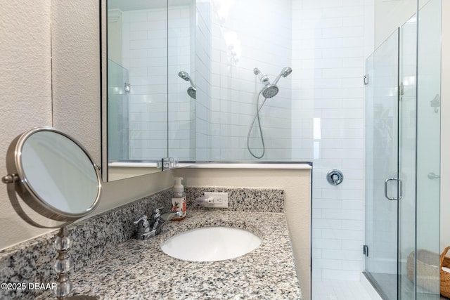 bathroom featuring vanity and an enclosed shower