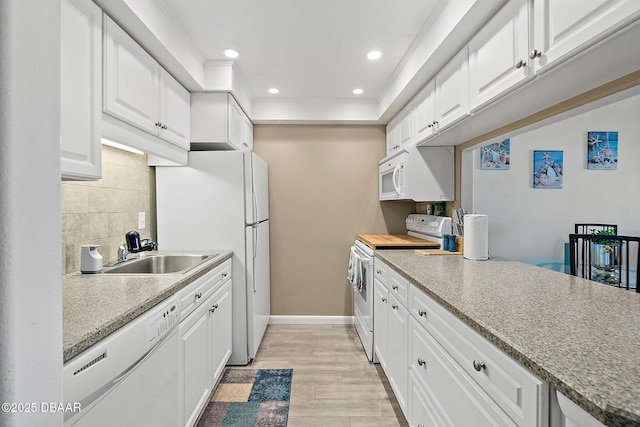 42 N Ocean Palm Villa, Flagler Beach, FL 32136 - kitchen featuring sink, white appliances, white cabinets, and backsplash