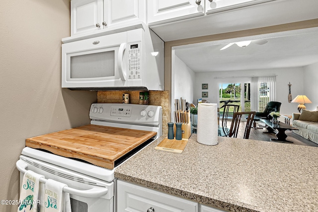 42 N Ocean Palm Villa, Flagler Beach, FL 32136 - kitchen featuring white cabinetry, white appliances, and hardwood / wood-style flooring
