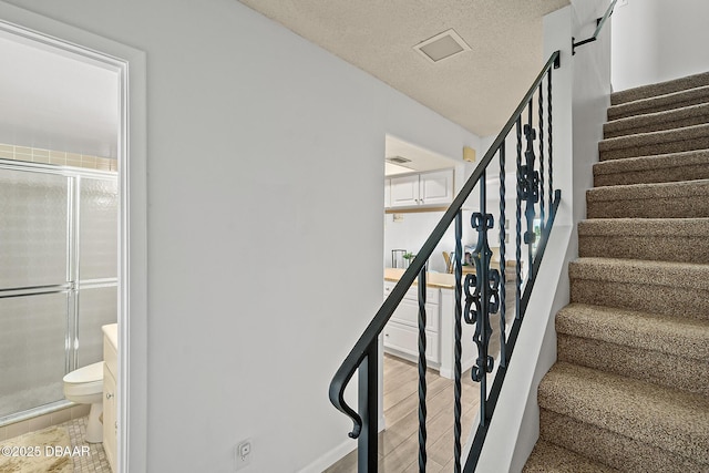 42 N Ocean Palm Villa, Flagler Beach, FL 32136 - staircase with wood-type flooring and a textured ceiling