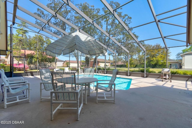 outdoor pool with glass enclosure and a patio area