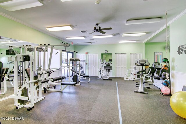 gym featuring ceiling fan, visible vents, and ornamental molding