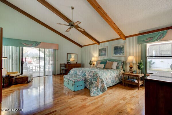 bedroom featuring beamed ceiling, light wood-style floors, access to exterior, and high vaulted ceiling