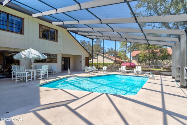 outdoor pool with a lanai and a patio