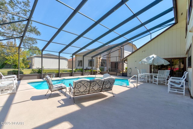 outdoor pool with a lanai and a patio